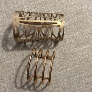 2 gold cuff bracelets.
